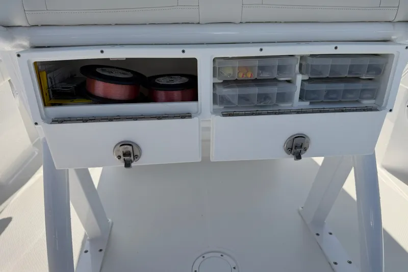 Slide: The Image of 2024 Bluewater BW 25T boat storage compartments with fishing gear and tackle boxes. - 44