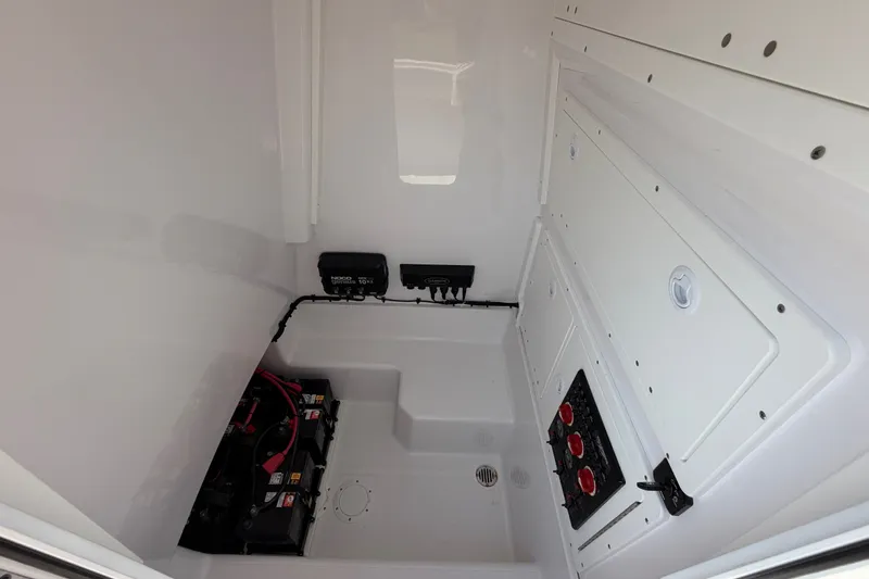 Slide: The Image of 2024 Bluewater BW 25T boat interior showing battery compartment and electrical panel. - 52
