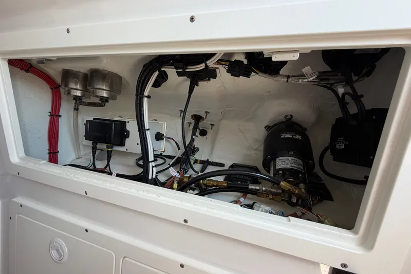 Slide: The Image of 2024 Bluewater BW 25T boat compartment showcasing wiring and mechanical components. - 59