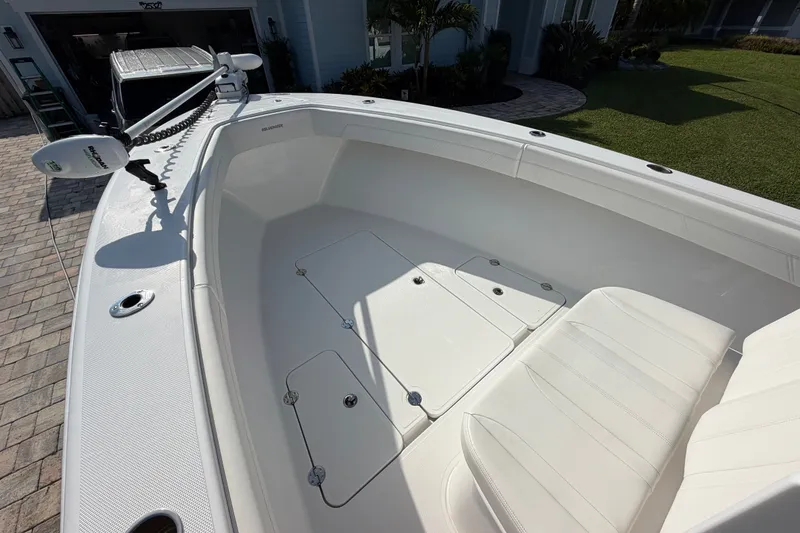 Slide: The Image of 2024 Bluewater BW 25T boat interior with white seating and storage compartments. - 32