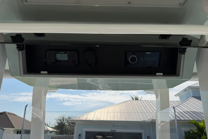 Slide: The Image of 2024 Bluewater BW 25T boat console with Garmin and Fusion electronics under a clear sky. - 33