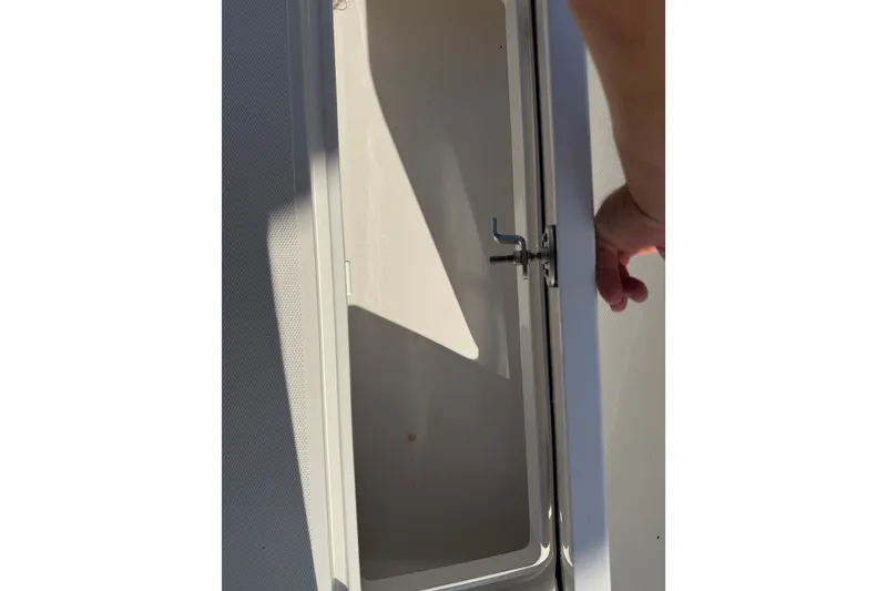 Slide: The Image of Open storage compartment on 2024 Bluewater BW 25T boat. - 46