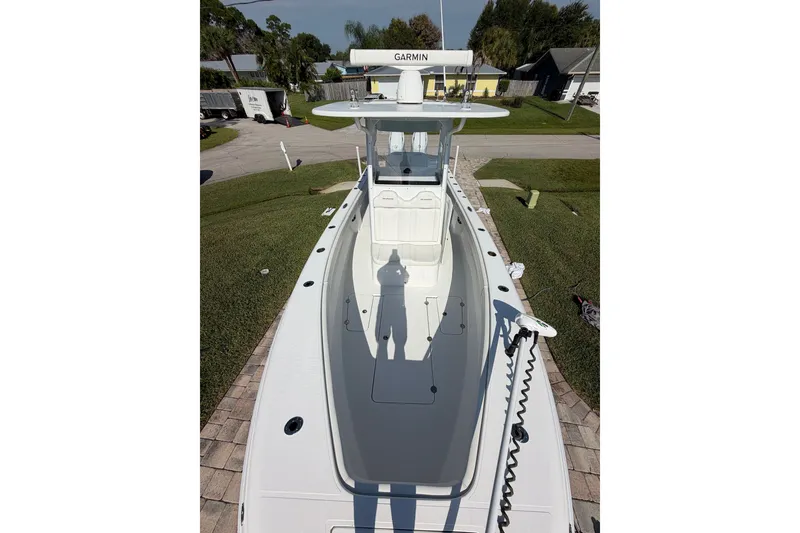 Slide: The Image of 2024 Bluewater BW 25T boat with Garmin equipment, parked on a driveway. - 29