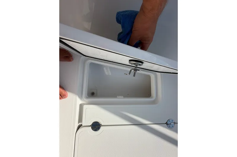 Slide: The Image of 2024 Bluewater BW 25T boat compartment being cleaned with a blue cloth. - 51