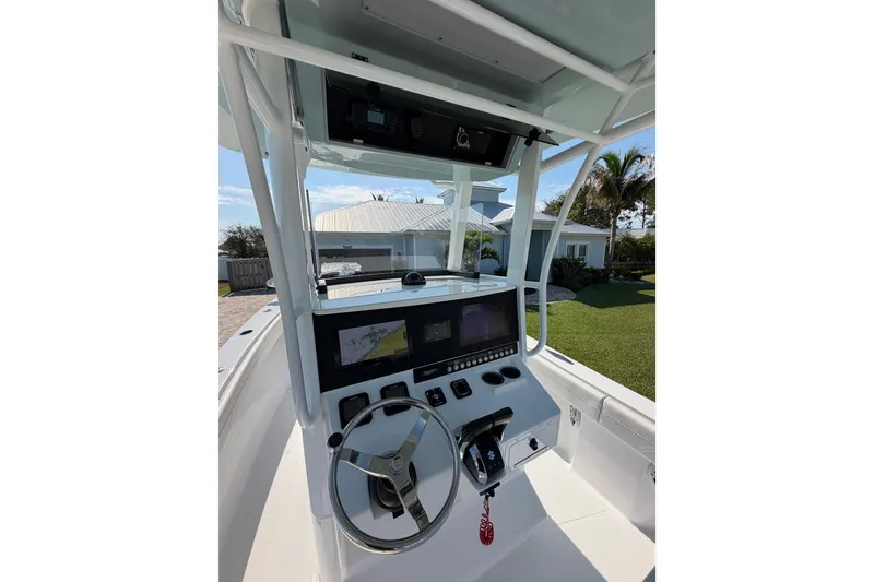 Slide: The Image of 2024 Bluewater BW 25T boat console with steering wheel and navigation screens. - 28