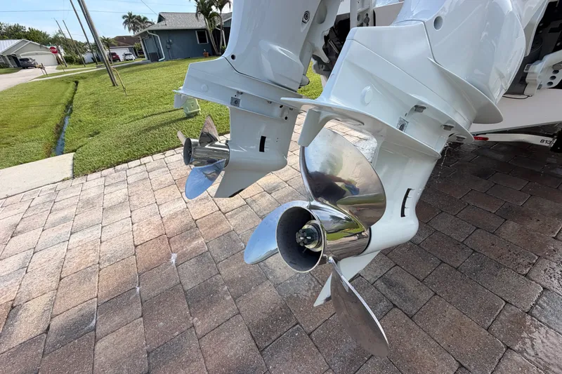 Slide: The Image of 2024 Bluewater BW 25T boat propellers on a paved driveway, showcasing sleek design. - 61