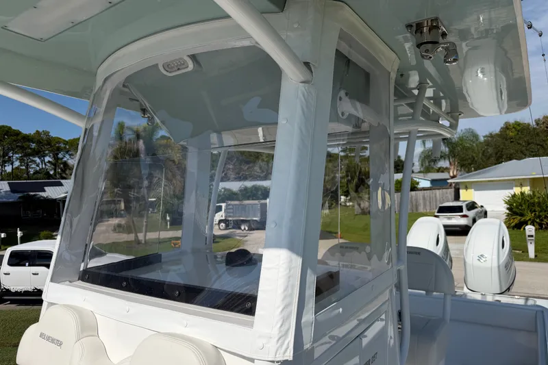 Slide: The Image of 2024 Bluewater BW 25T boat with enclosed helm and dual engines. - 14