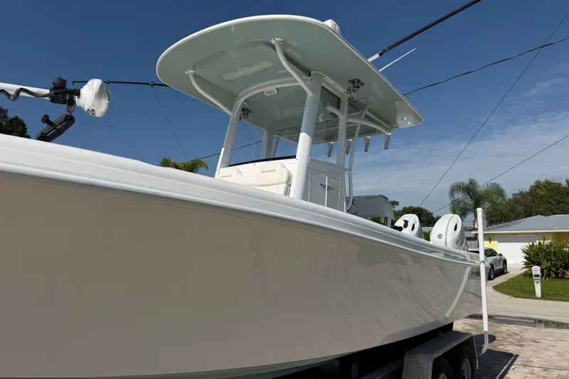 Slide: The Image of 2024 Bluewater BW 25T boat on trailer, showcasing sleek design and modern features. - 19