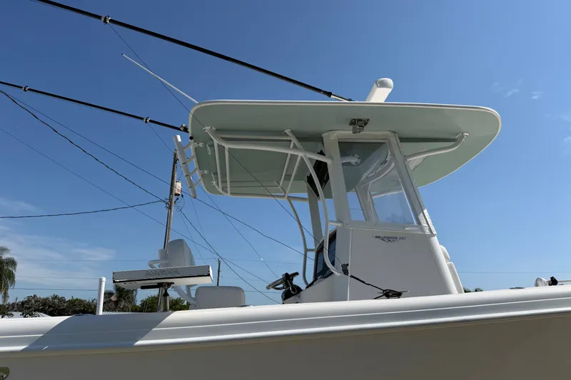 Slide: The Image of 2024 Bluewater BW 25T boat with T-top under clear blue sky. - 13