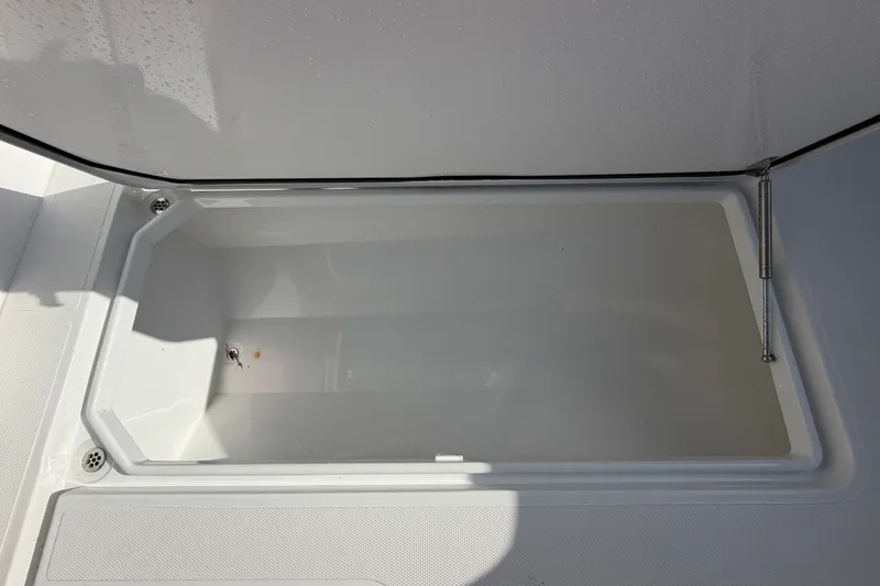 Slide: The Image of Open storage compartment on 2024 Bluewater BW 25T boat, showcasing spacious interior design. - 50