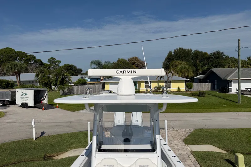 Slide: The Image of 2024 Bluewater BW 25T boat with Garmin radar, parked in a residential area. - 30