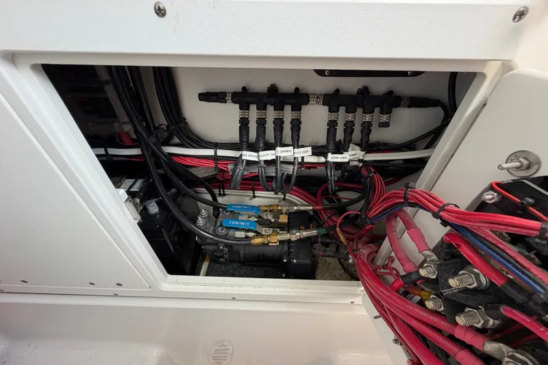 Slide: The Image of Electrical wiring and components inside a 2024 Bluewater BW 25T boat. - 57