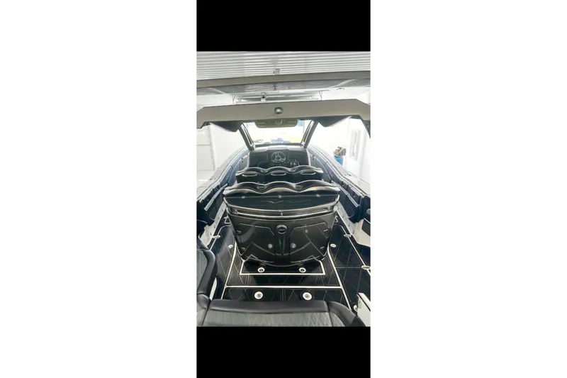 Slide: The Image of Interior view of a 2018 MTI V42 boat, showcasing luxurious seating and sleek design. - 13