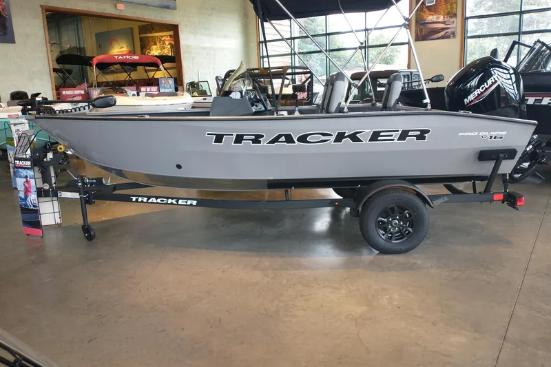 The Image of 2027 Tracker Pro Guide V-16 SC boat displayed indoors on a trailer. - 0