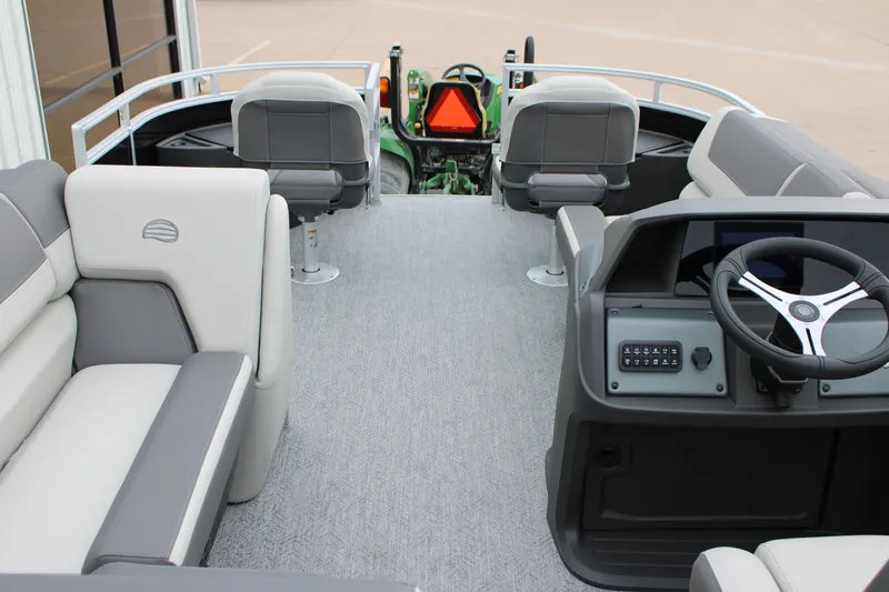 Slide: The Image of Interior view of 2027 Sun Tracker Fishin' Barge 20 DLX pontoon boat with seating and steering console. - 21
