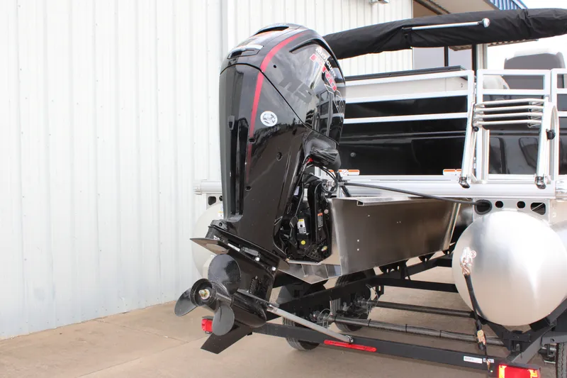 Slide: The Image of 2027 Sun Tracker Fishin' Barge 20 DLX with powerful outboard motor, docked outdoors. - 15