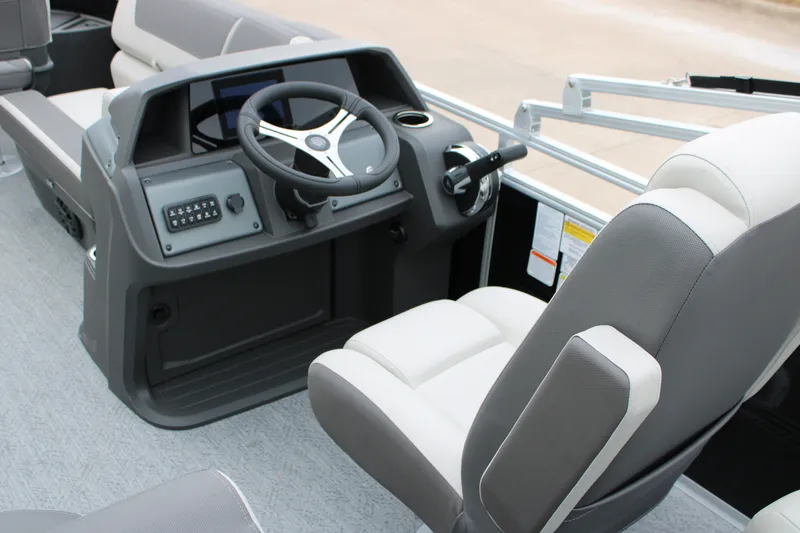 Slide: The Image of 2027 Sun Tracker Fishin' Barge 20 DLX helm with modern steering and controls. - 27