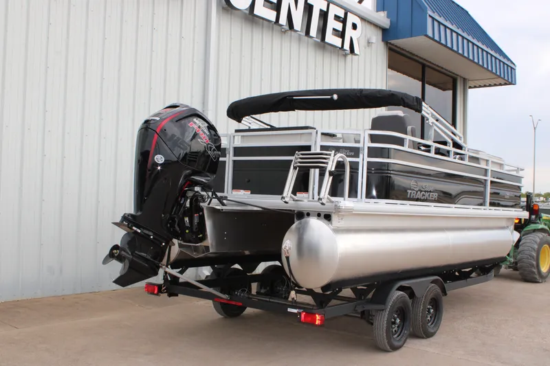 Slide: The Image of 2027 Sun Tracker Fishin' Barge 20 DLX pontoon boat with outboard motor on trailer. - 14