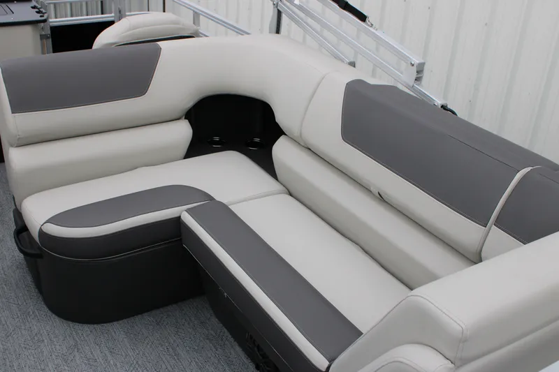 Slide: The Image of 2027 Sun Tracker Fishin' Barge 20 DLX interior seating, featuring gray and white upholstery. - 18