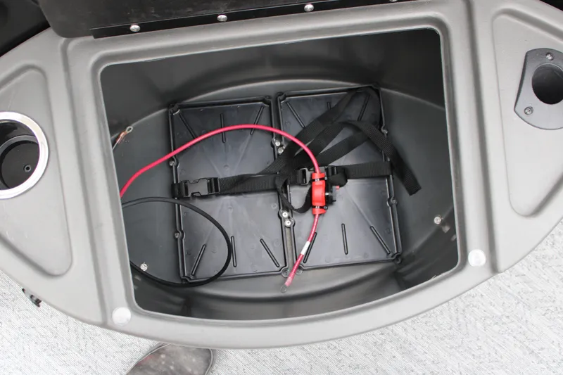 Slide: The Image of Storage compartment of 2027 Sun Tracker Fishin' Barge 20 DLX with wiring and straps. - 22