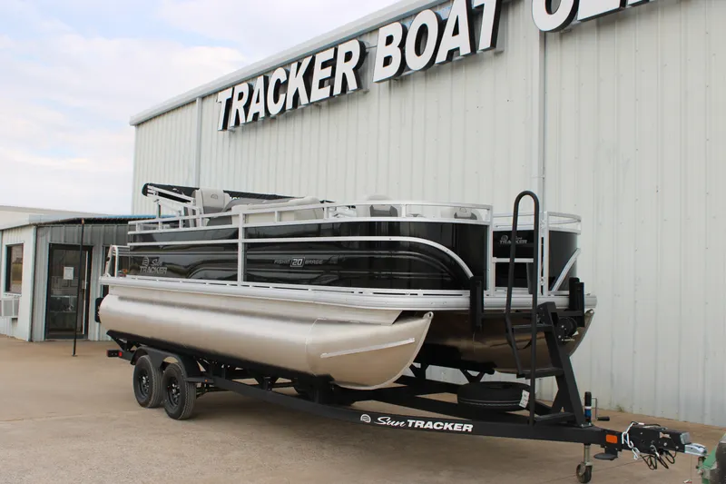Slide: The Image of 2027 Sun Tracker Fishin' Barge 20 DLX pontoon boat on trailer outside dealership. - 13