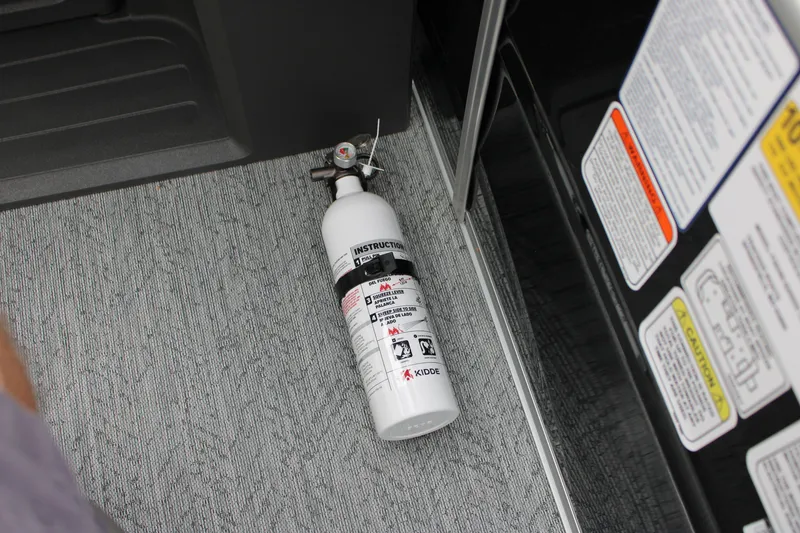 Slide: The Image of Fire extinguisher on Sun Tracker Fishin' Barge 20 DLX 2027 boat interior floor. - 35