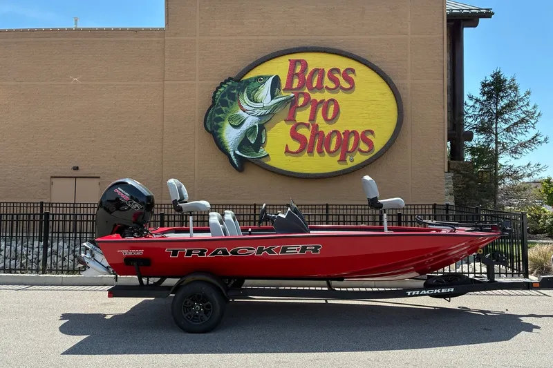 The Image of Red 2027 Tracker Pro Team 195 boat parked outside Bass Pro Shops. - 0