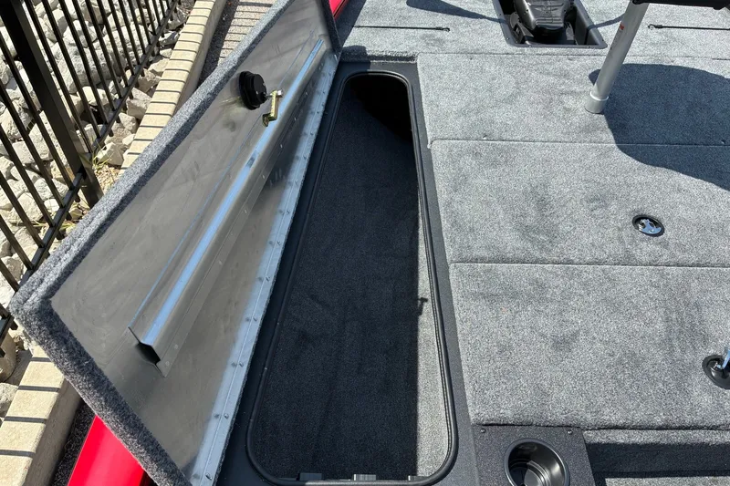 Slide: The Image of Open storage compartment on 2027 Tracker Pro Team 195 boat deck. - 13