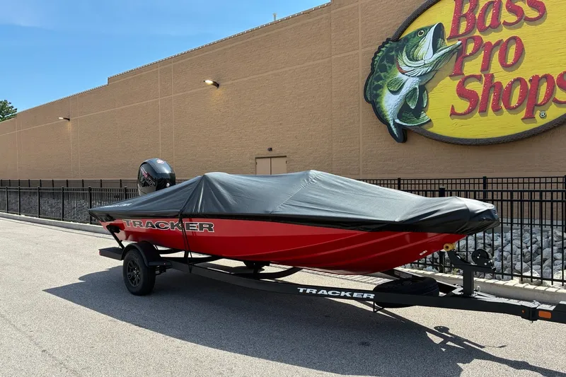 Slide: The Image of 2027 Tracker Pro Team 195 boat covered, parked outside Bass Pro Shops. - 17