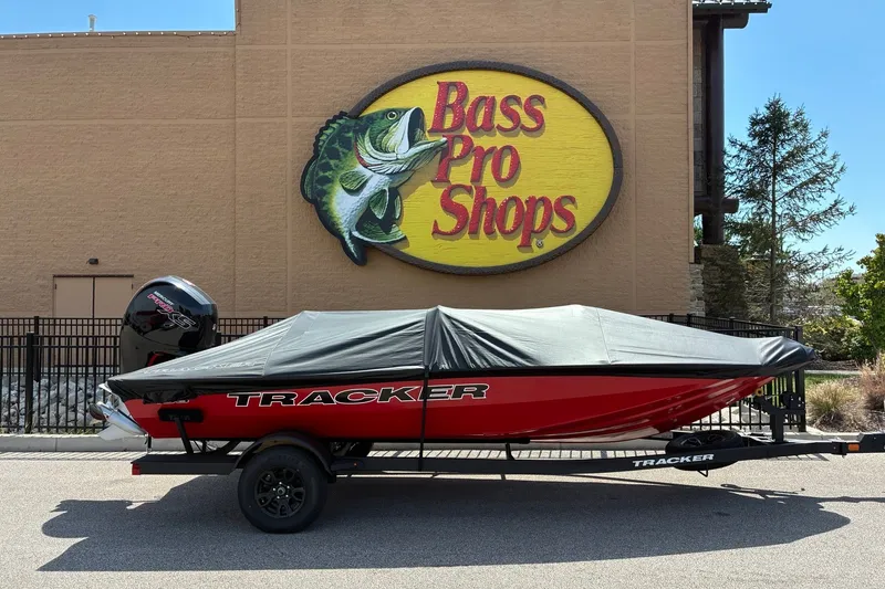 Slide: The Image of 2027 Tracker Pro Team 195 boat covered, parked outside Bass Pro Shops. - 16