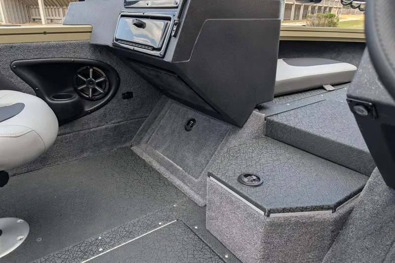 Slide: The Image of Interior of a 2027 Tracker Targa V-19 Combo boat, featuring seating and speaker system. - 14
