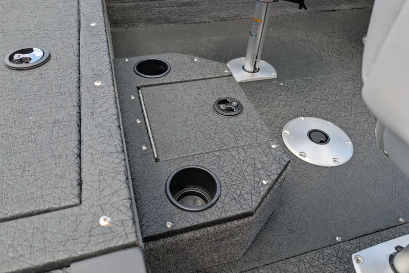 Slide: The Image of 2027 Tracker Targa V-19 Combo boat interior with cup holders and textured flooring. - 13
