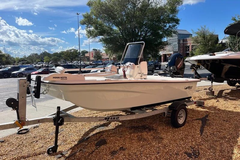 Slide: The Image of 2025 Mako Pro Skiff 13 CC boat on trailer in outdoor setting. - 1