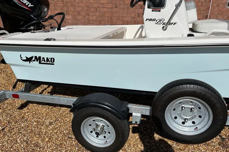 Slide: The Image of 2025 Mako Pro Skiff 13 CC boat on trailer, featuring sleek design and branding. - 6