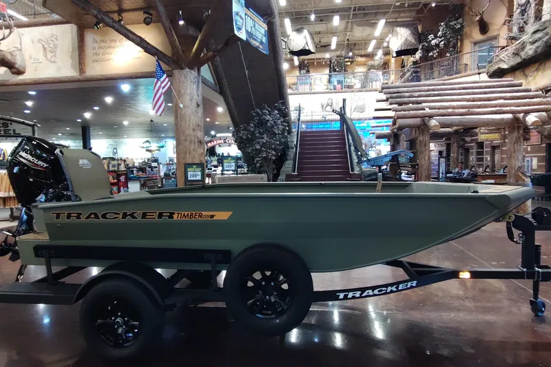 The Image of 2027 Tracker Grizzly 1553 Timber boat displayed indoors, showcasing its sleek design and features. - 0