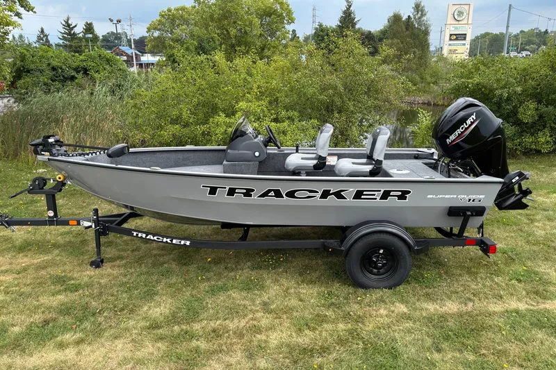 The Image of 2027 Tracker Super Guide V-16 SC boat on trailer, parked on grass. - 0