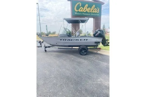 The Image of 2027 Tracker Pro Guide V-16 WT boat on trailer outside Cabela's store. - 0