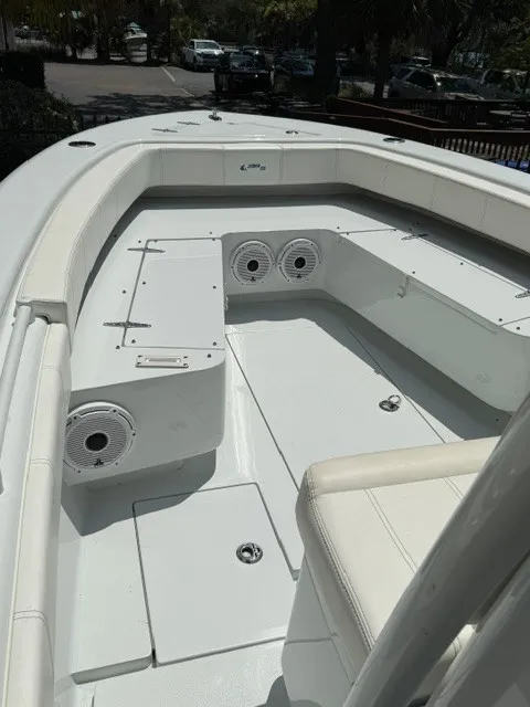 Slide: The Image of The image shows the cockpit of a 2020 Contender 28 Sport boat with white upholstery and speakers. - 8
