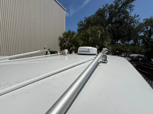Slide: The Image of The image shows the roof of a Contender 28 Sport boat with a Garmin antenna. - 23