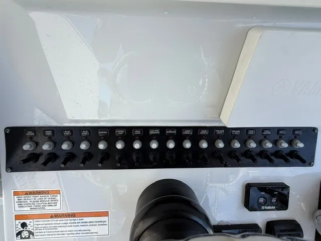 Slide: The Image of Control panel with toggle switches and labels on a boat. - 16
