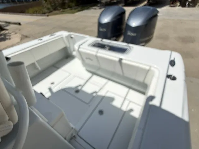 Slide: The Image of The image shows the cockpit of a 2020 Contender 28 Sport boat with two outboard engines. - 19