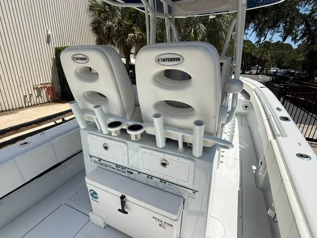 Slide: The Image of The image shows the cockpit of a 2020 Contender 28 Sport boat with white seats and rod holders. - 21