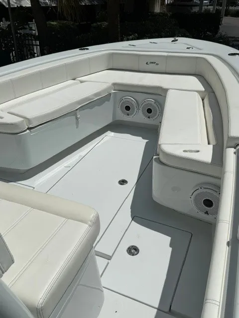 Slide: The Image of The image shows the cockpit of a 2020 Contender 28 Sport boat with white upholstery and speakers. - 10