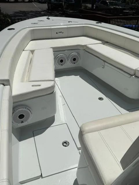 Slide: The Image of The image shows the cockpit of a 2020 Contender 28 Sport boat with white upholstery. - 9