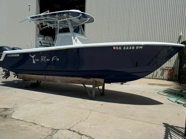 Slide: The Image of A 2020 Contender 28 Sport boat is on a dry dock in front of a building. - 4