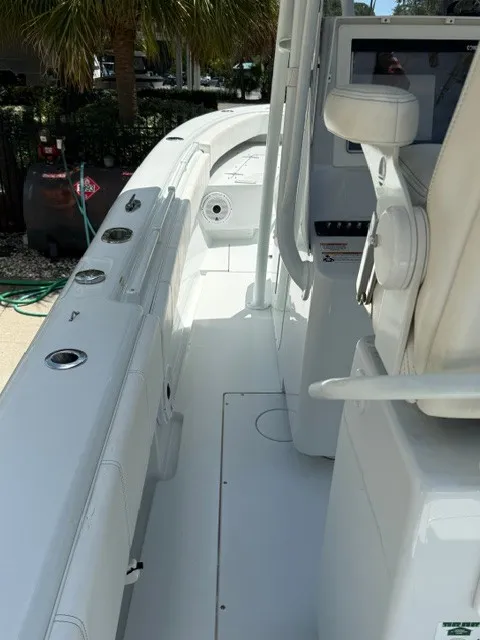 Slide: The Image of The image shows the cockpit of a 2020 Contender 28 Sport boat with white seating and helm. - 7