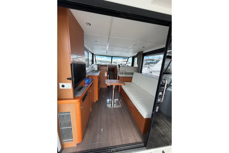 Slide: The Image of Interior of 2017 Beneteau Swift Trawler 30, featuring modern seating and wooden cabinetry. - 35