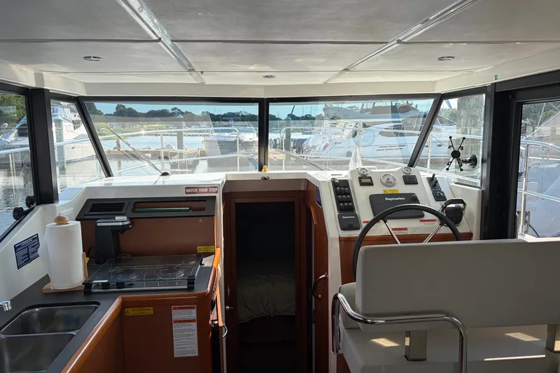 Slide: The Image of Interior view of a 2017 Beneteau Swift Trawler 30, featuring helm and galley area. - 31