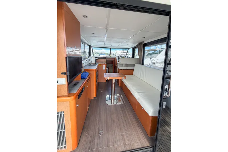 Slide: The Image of Interior of 2017 Beneteau Swift Trawler 30, featuring modern seating and wooden finishes. - 66
