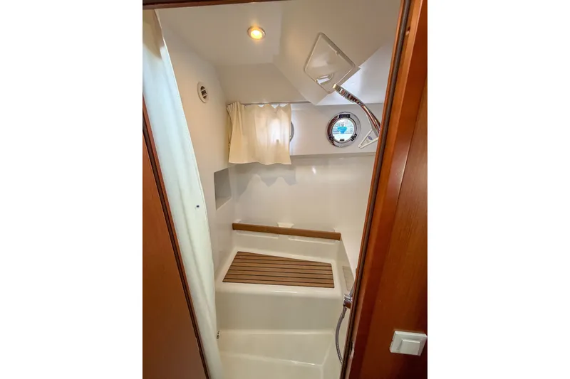 Slide: The Image of Bathroom interior of 2017 Beneteau Swift Trawler 30 with shower and wooden accents. - 55
